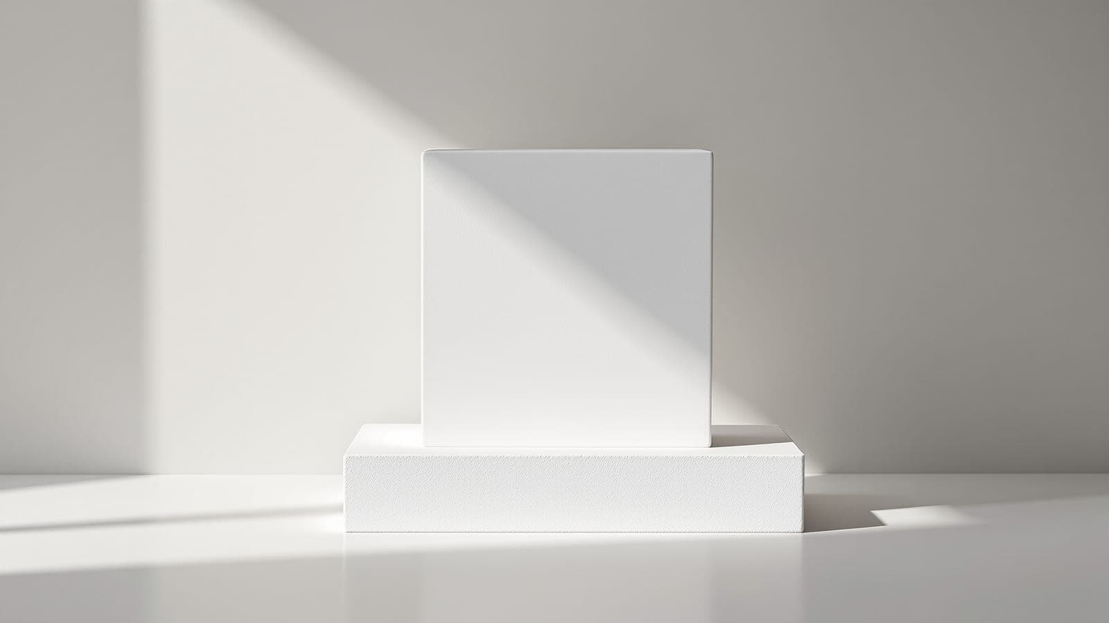 A white foam form standing on a plain base, lit cleanly for photography against a neutral backdrop and casting a crisp shadow, seen straight on