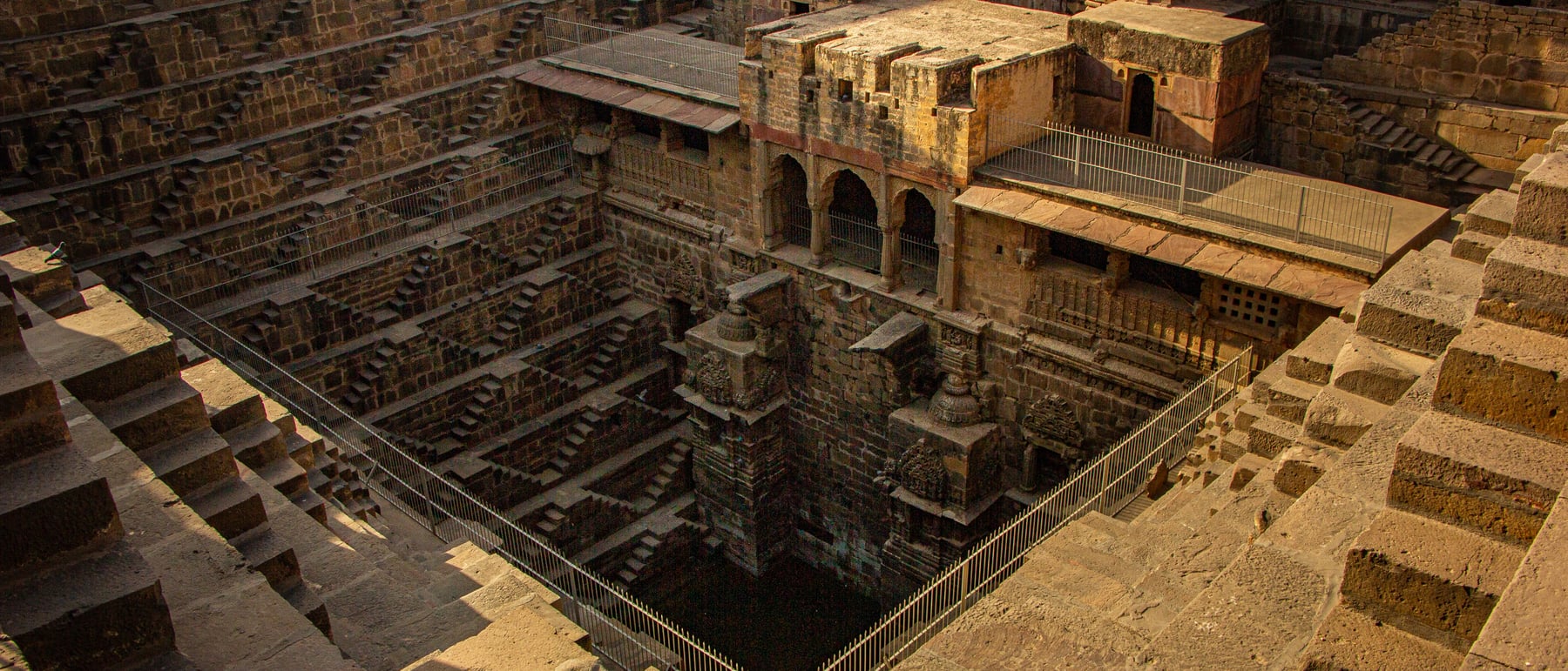 Chand Baori (stepwell) — 3,500 steps descending in dizzying geometry.