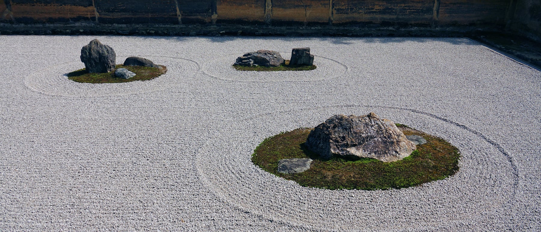 Ryōan-ji rock garden — Fifteen stones in raked gravel — space as contemplation.