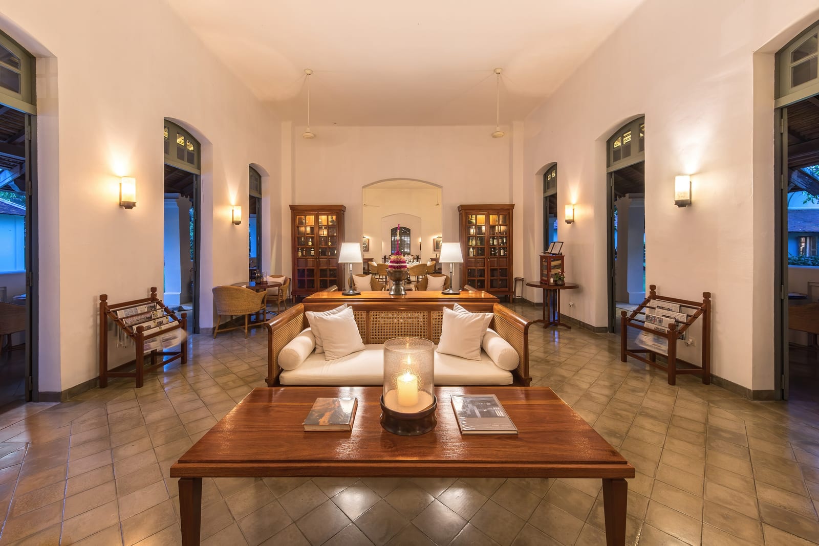 A hotel lounge where loose seating groups carve the open floor into intimate zones without a single dividing wall.