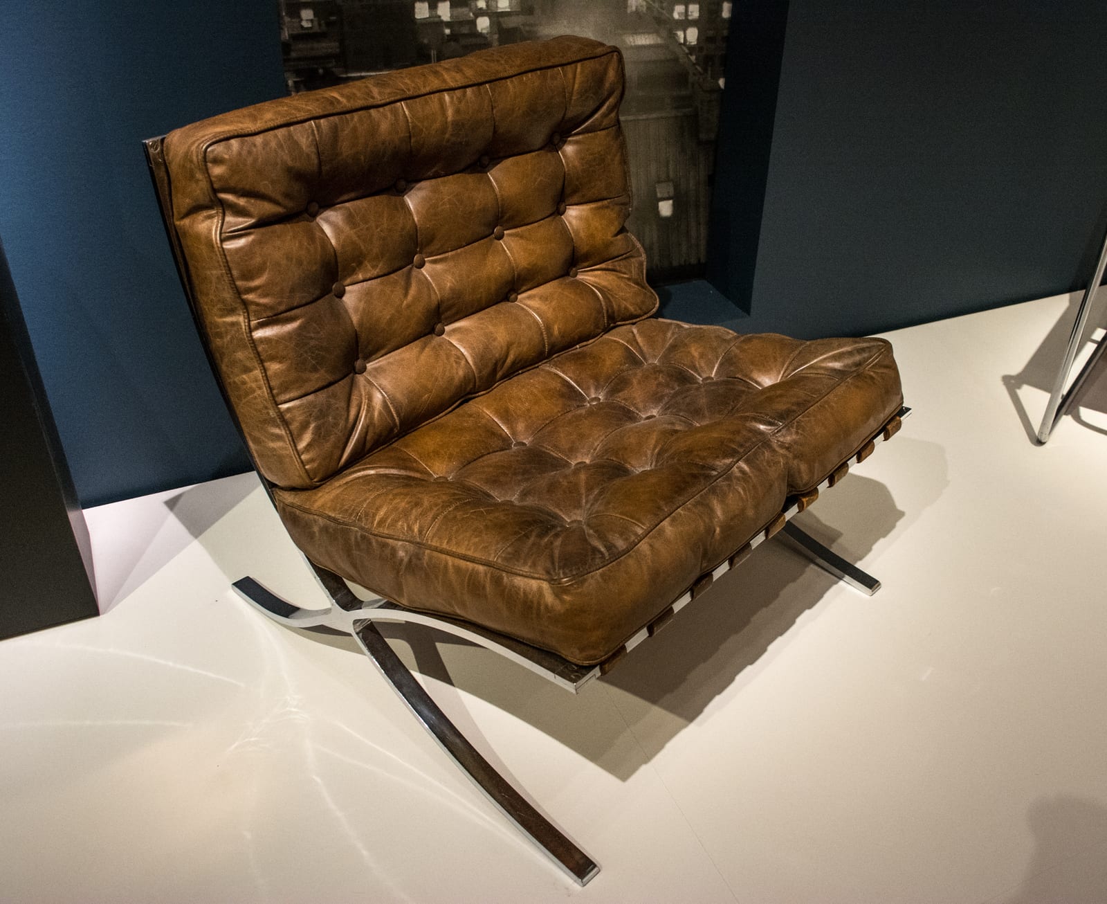 Mies van der Rohe & Lilly Reich's Barcelona chair (1929) — chromed flat-bar and buttoned leather, industrial material turned to modern luxury.
