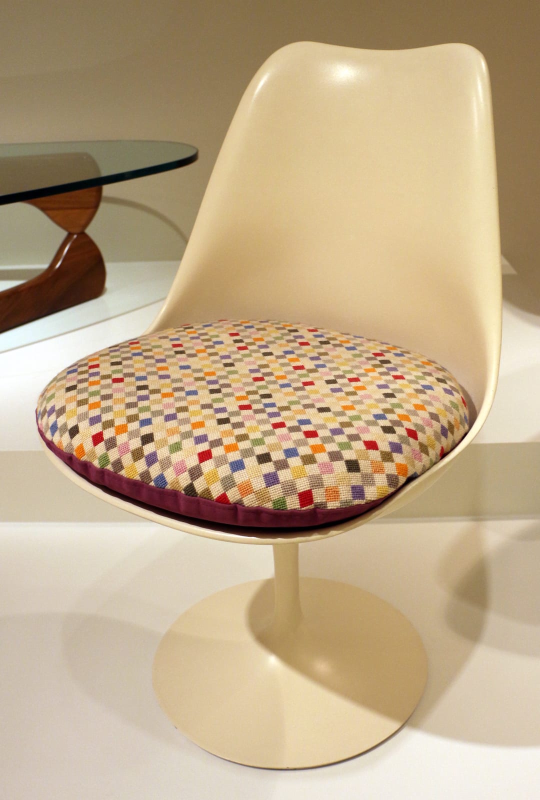 Eero Saarinen's Tulip chair (1956) — a moulded shell on a single pedestal, clearing the 'slum of legs' under the table.