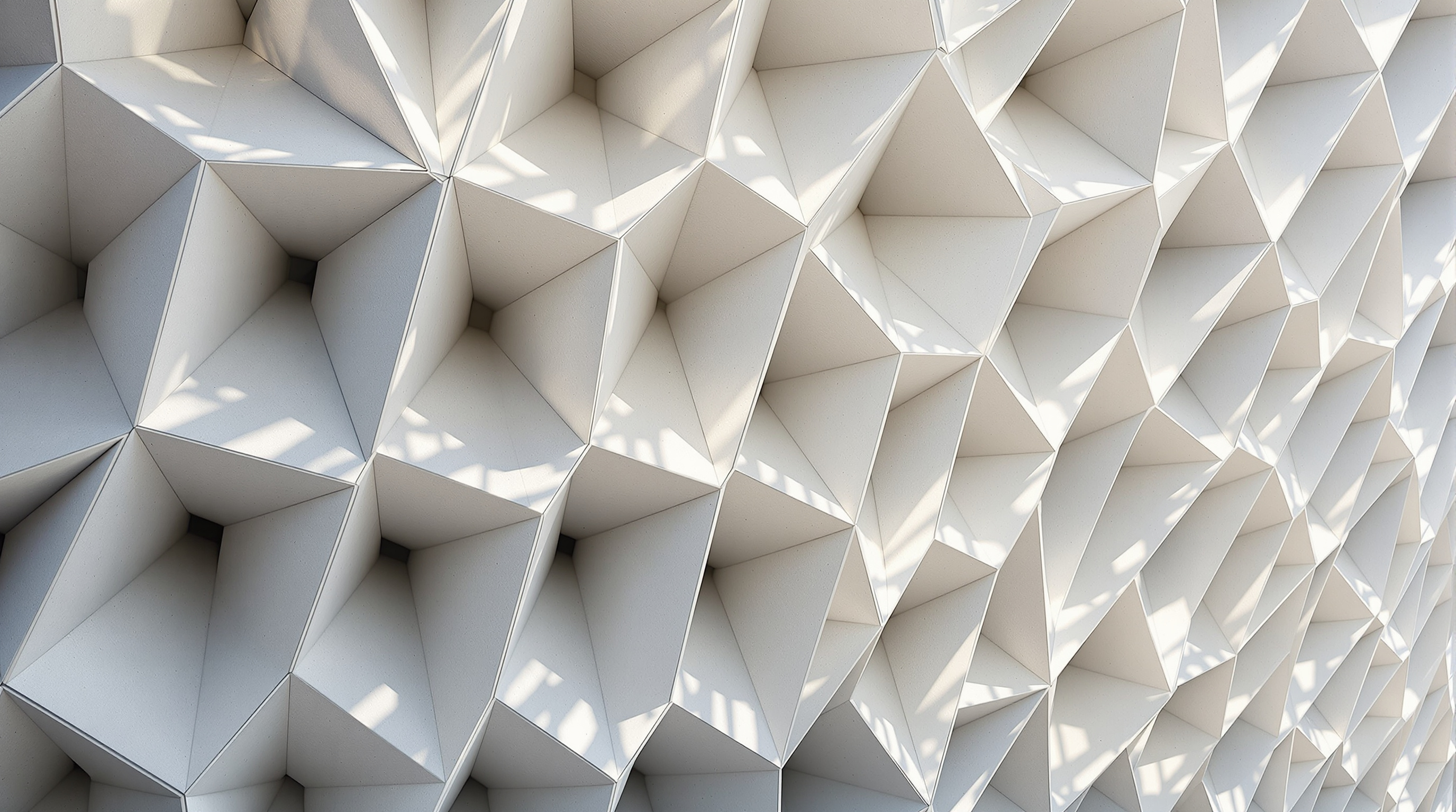 Detail of The Broad's veil: the deep, angled cells of glass-fibre-reinforced-concrete lifting away from the glass wall behind, raking California light cutting diagonal shadows across the honeycomb, the pale grey lattice reading as a single continuous cast surface