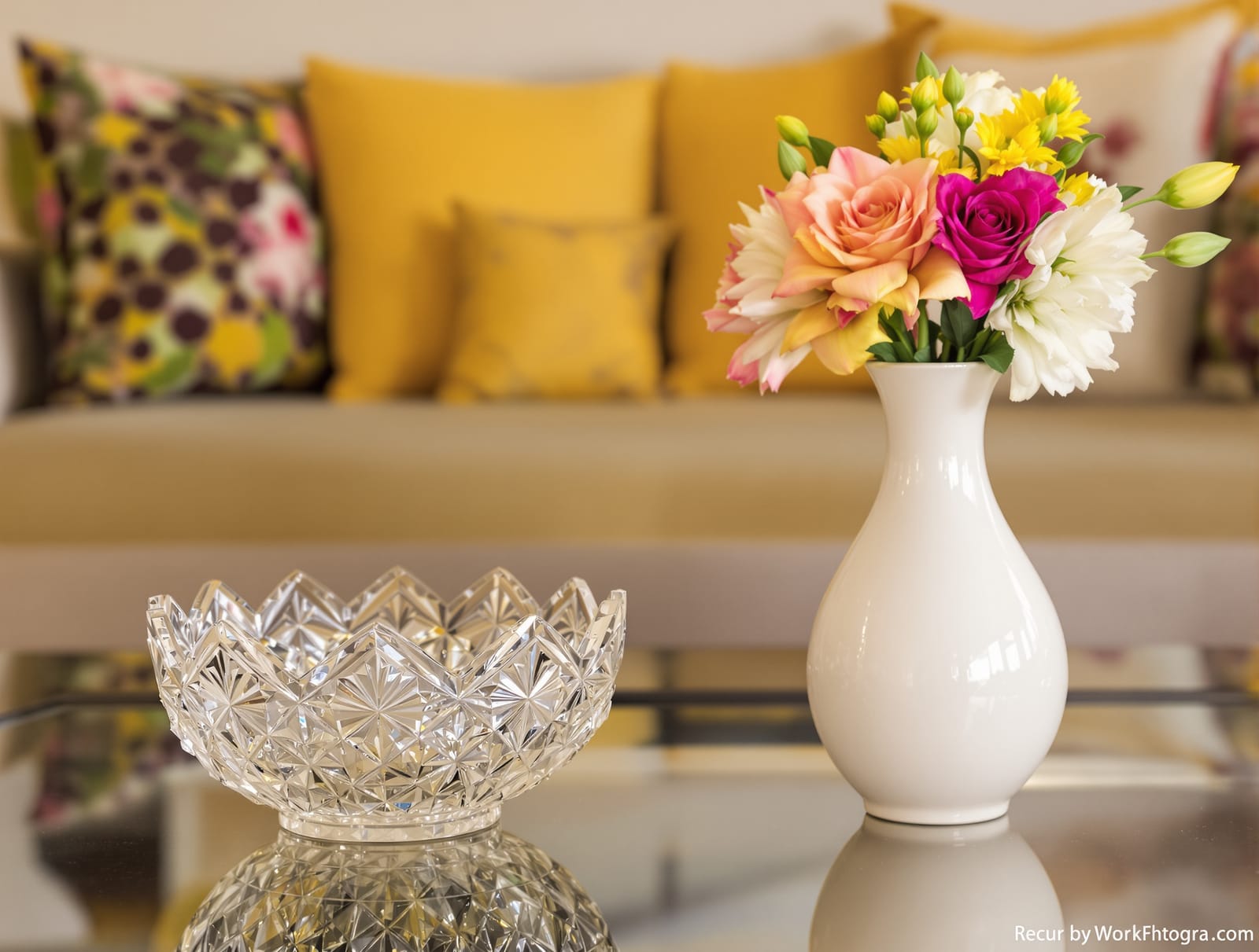 A crystal bowl and vases on a coffee table