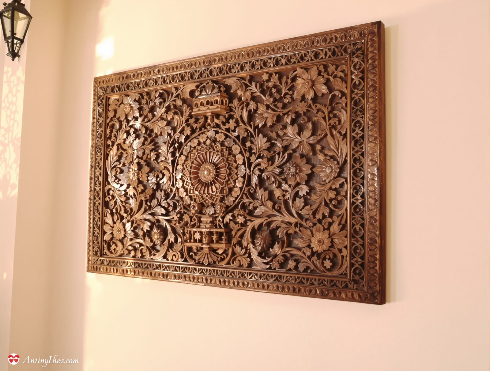 An antique hand-carved wooden panel as wall decor in an Indian home