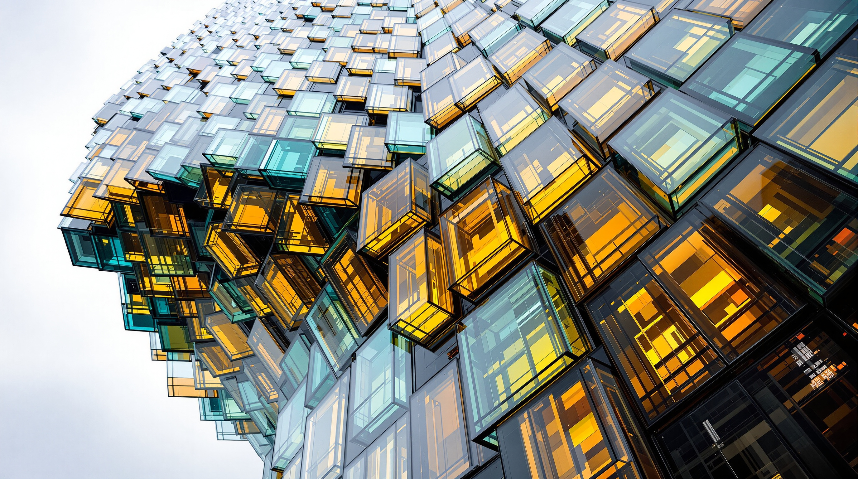 Detail of Harpa's south façade seen from below, the stacked three-dimensional quasi-brick modules of steel and colour-effect glass receding upward, each facet holding a different tint of amber, blue and mirror-grey as daylight rakes across the crystalline wall
