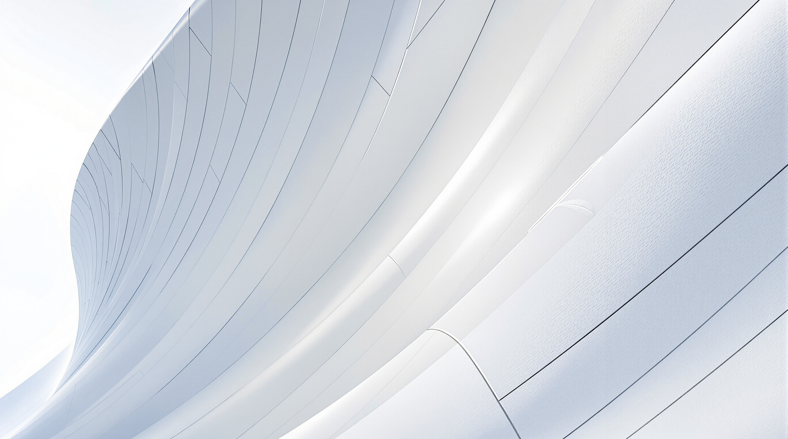 Close-up of the smooth, seamless white cladding panels of the Heydar Aliyev Center curving across the façade, the thin shadow-gap joints between individual GFRC panels visible in raking light