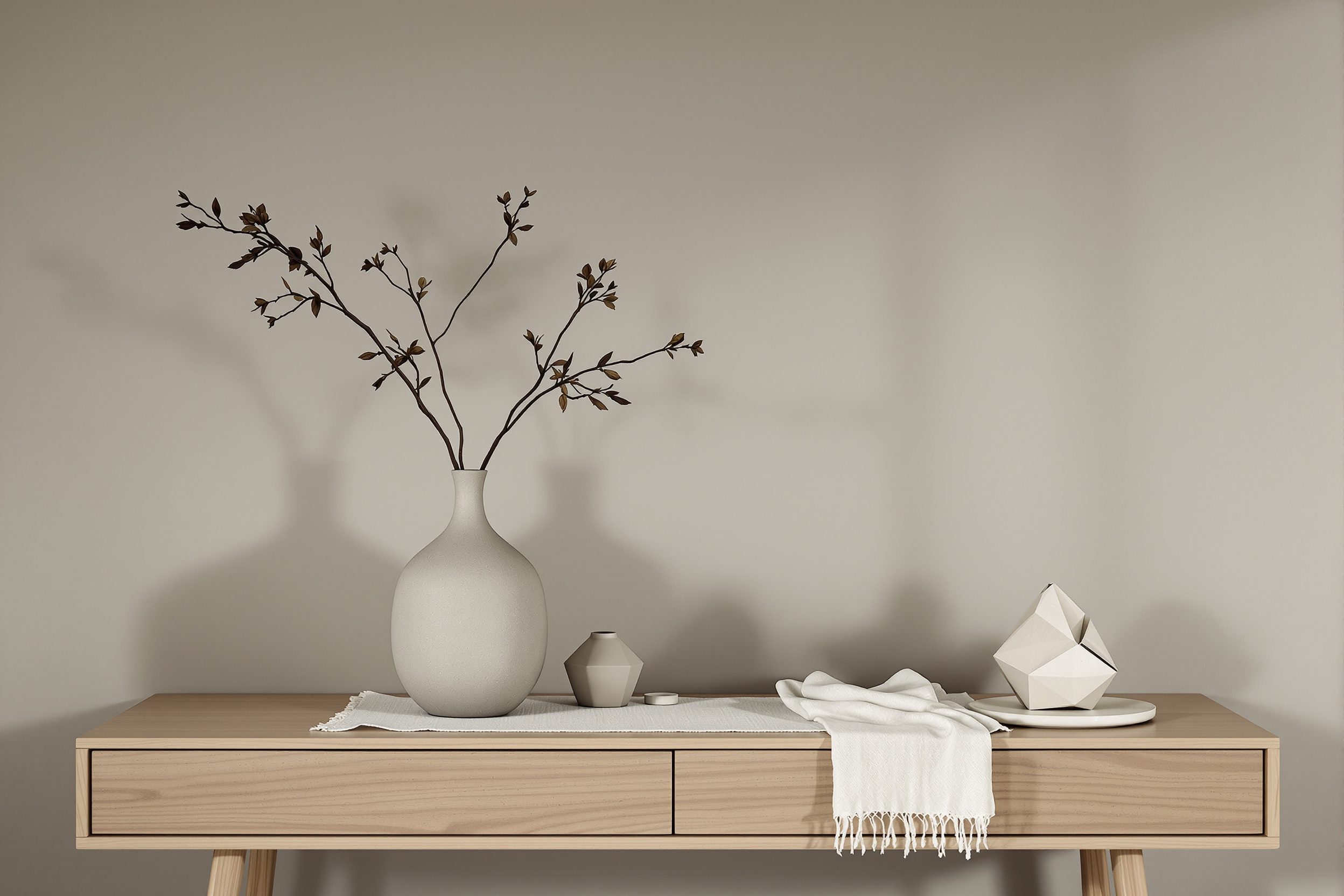 A Japandi-inspired console vignette with textured stoneware ceramics, a paper lamp and a single branch