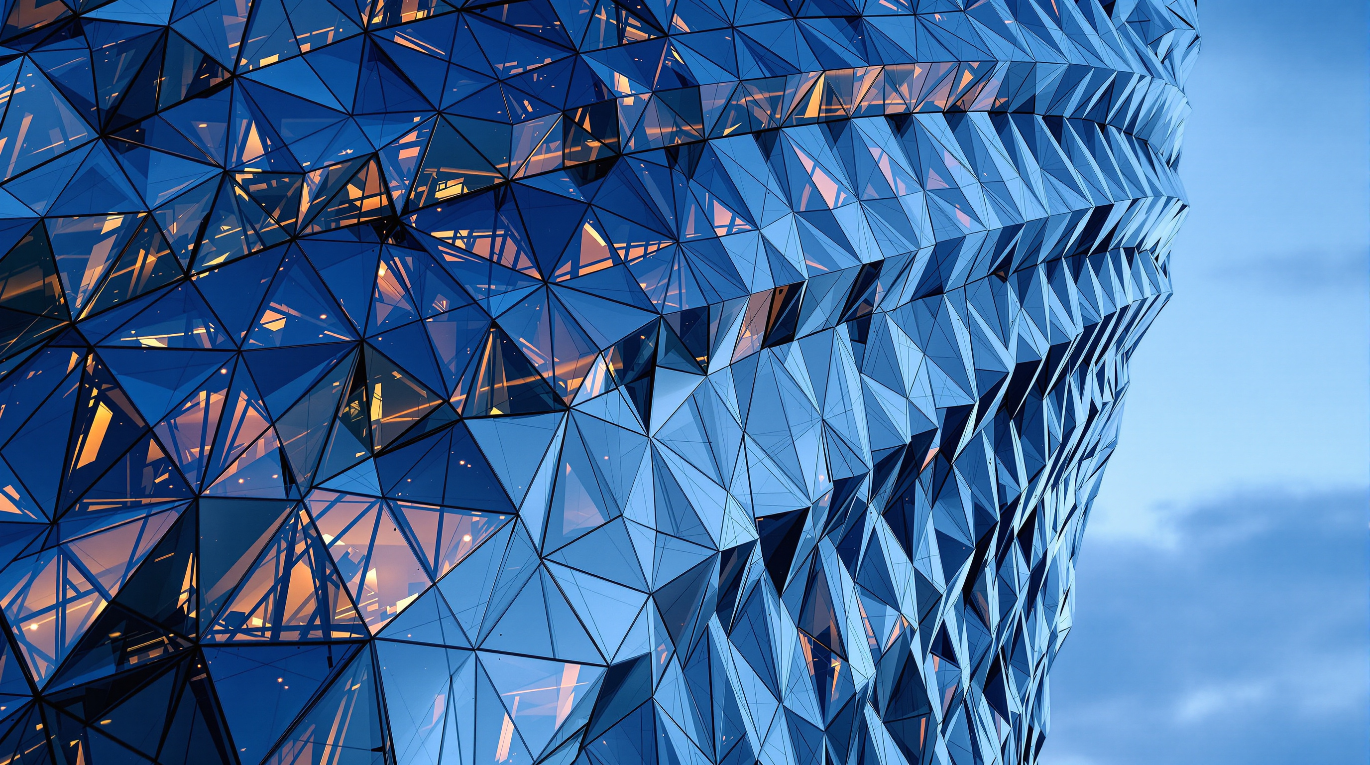 Close view of the Lakhta Center facade at dusk, its faceted cold-bent glass panels stepping and twisting across the surface, each pane reflecting the northern sky at a slightly different angle so the wall shimmers like fish scales