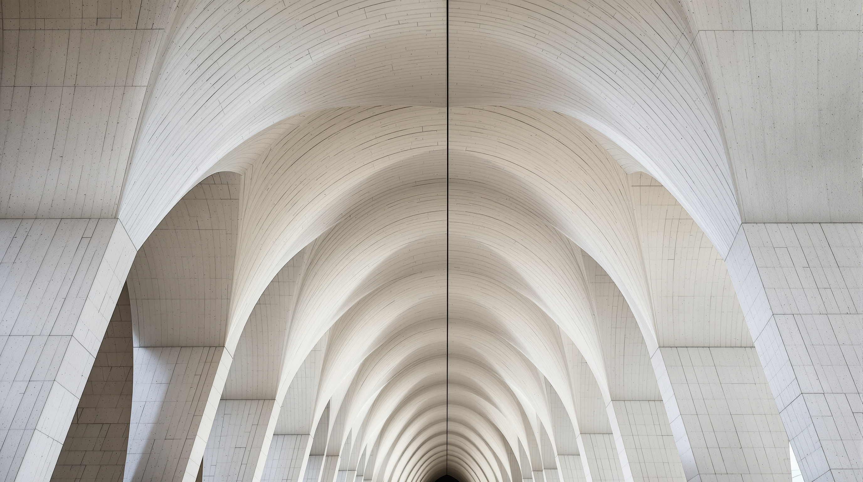 Looking up inside the Long Museum West Bund at a row of pale grey concrete vault-umbrellas, each column flaring smoothly outward at the top into a shallow arched ceiling, cool daylight washing down the curved surfaces and the board-marked texture of the cast concrete clearly visible