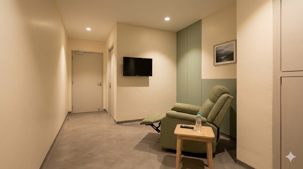 PET-CT uptake room — single recliner, low warm light, calm 60–90 minute isolation environment