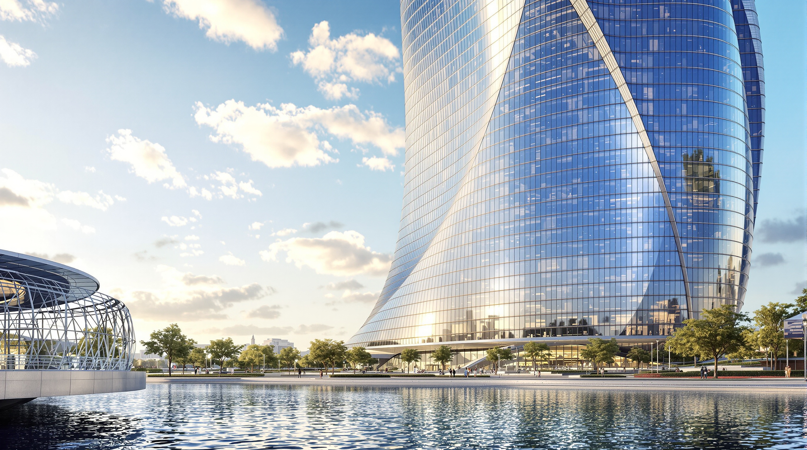 A ground-level view looking up along the twisting glass flank of one Naga tower, its serpentine curtain wall catching afternoon light, a landscaped riverfront promenade and reflecting water in the foreground