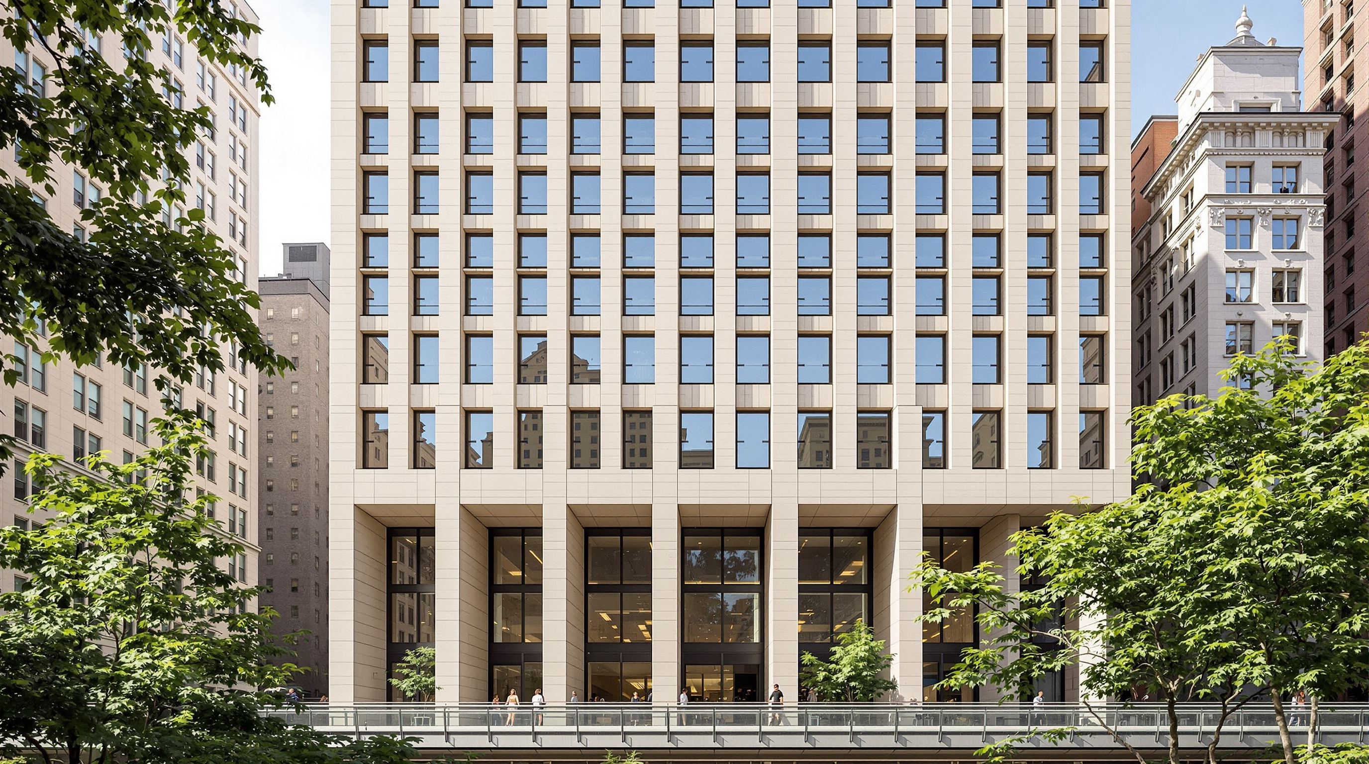 Looking up at the base of One High Line where the two towers angle apart over the High Line park, the travertine facade with its regular grid of vertical punched windows stepping to follow the sloping columns, pedestrians on the elevated walkway below