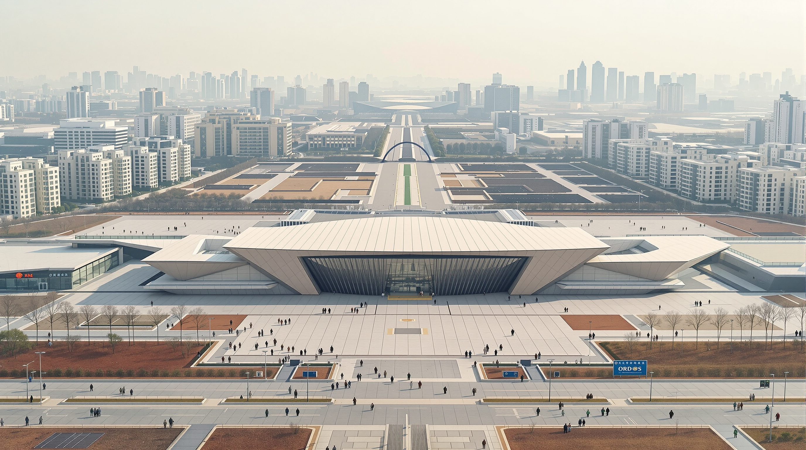 Wide view of the Ordos Museum standing amid the vast, sparsely populated paved plazas and distant apartment towers of Kangbashi, conveying the eerie scale and emptiness of the planned new city around it