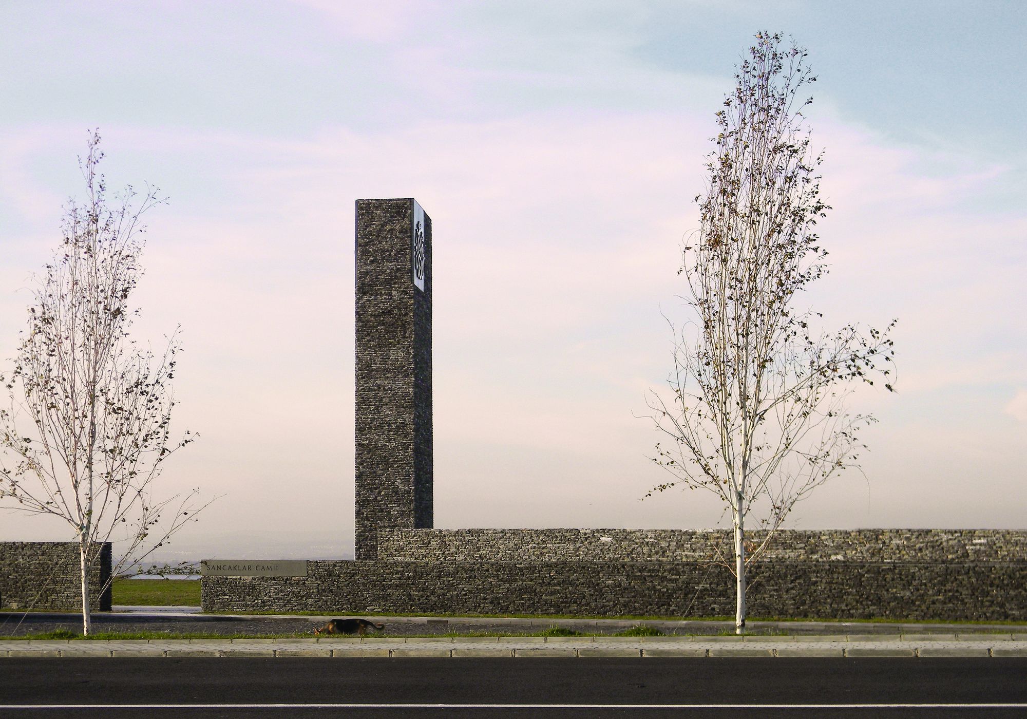 From the road there is almost nothing to see: only the tall split-stone minaret and a low perimeter wall inscribed 