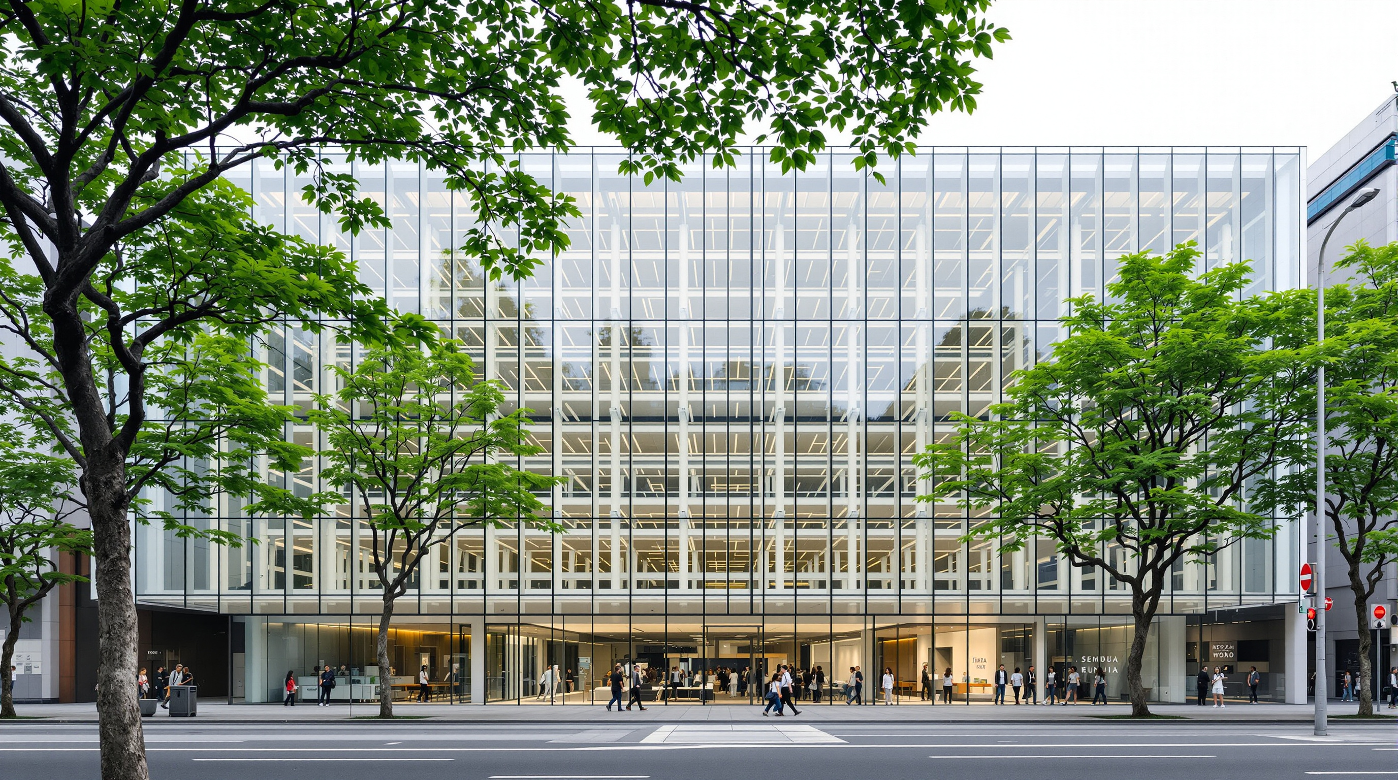 The Sendai Mediatheque seen from the tree-lined Jozenji-dori boulevard by day, its transparent glass facade reflecting the zelkova trees while the pale steel tubes and stacked floor plates remain visible through the skin