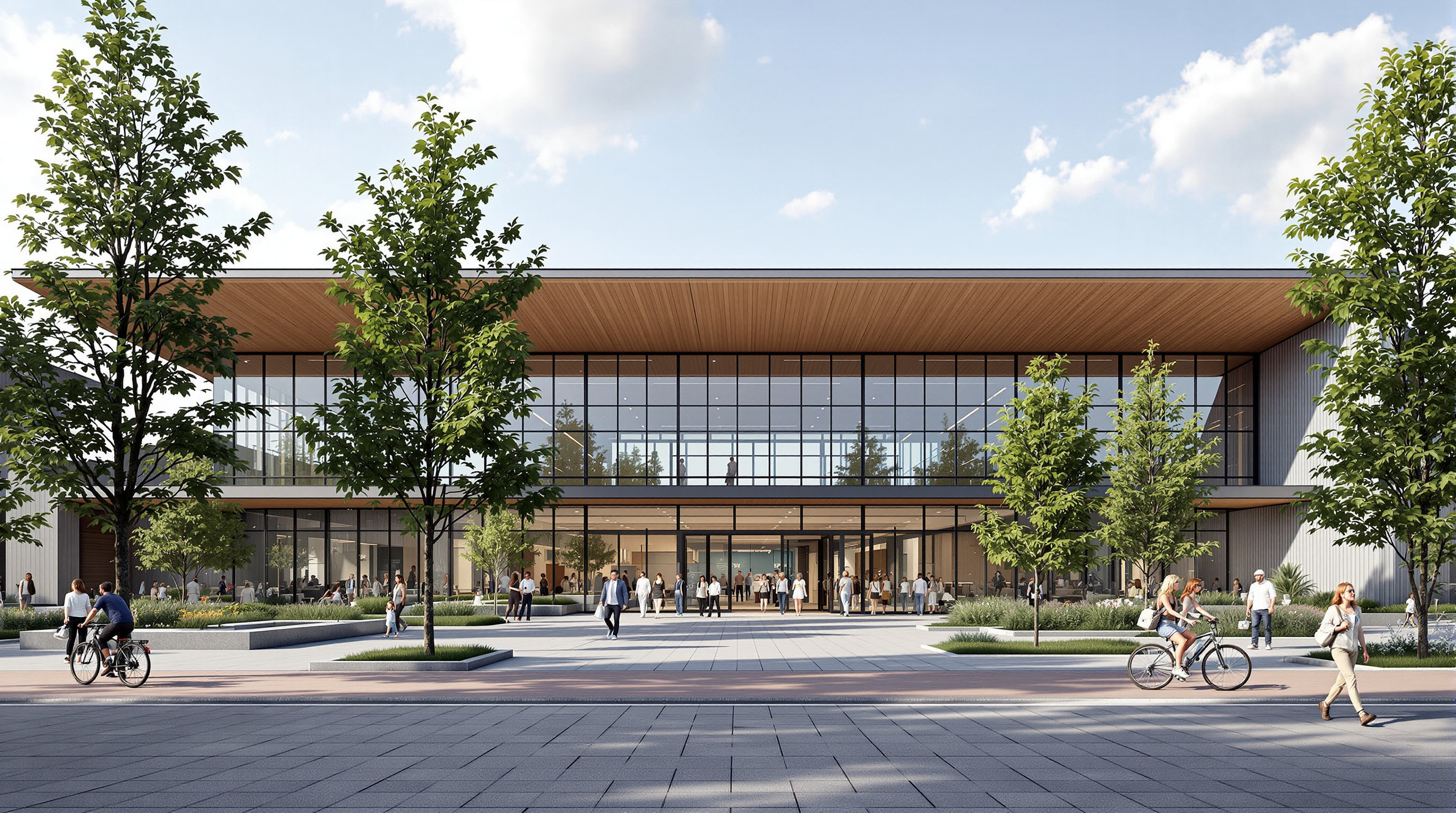 Exterior of the təməsew̓txʷ centre from the plaza: a long low civic building clad in standing-seam metal and glass, its folded timber roofline visible above the entrance, mature trees and a new public green in front, people arriving on foot and by bike