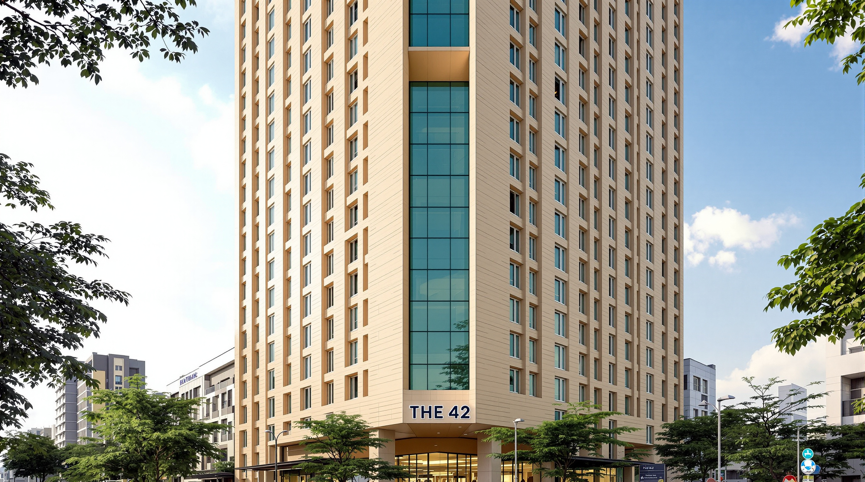 Looking straight up the corner of The 42 from street level, the slender square shaft receding to a distant crown, alternating triple-height terraces cut into the fawn-textured facade and the green-tinted glass reflecting a bright Kolkata sky