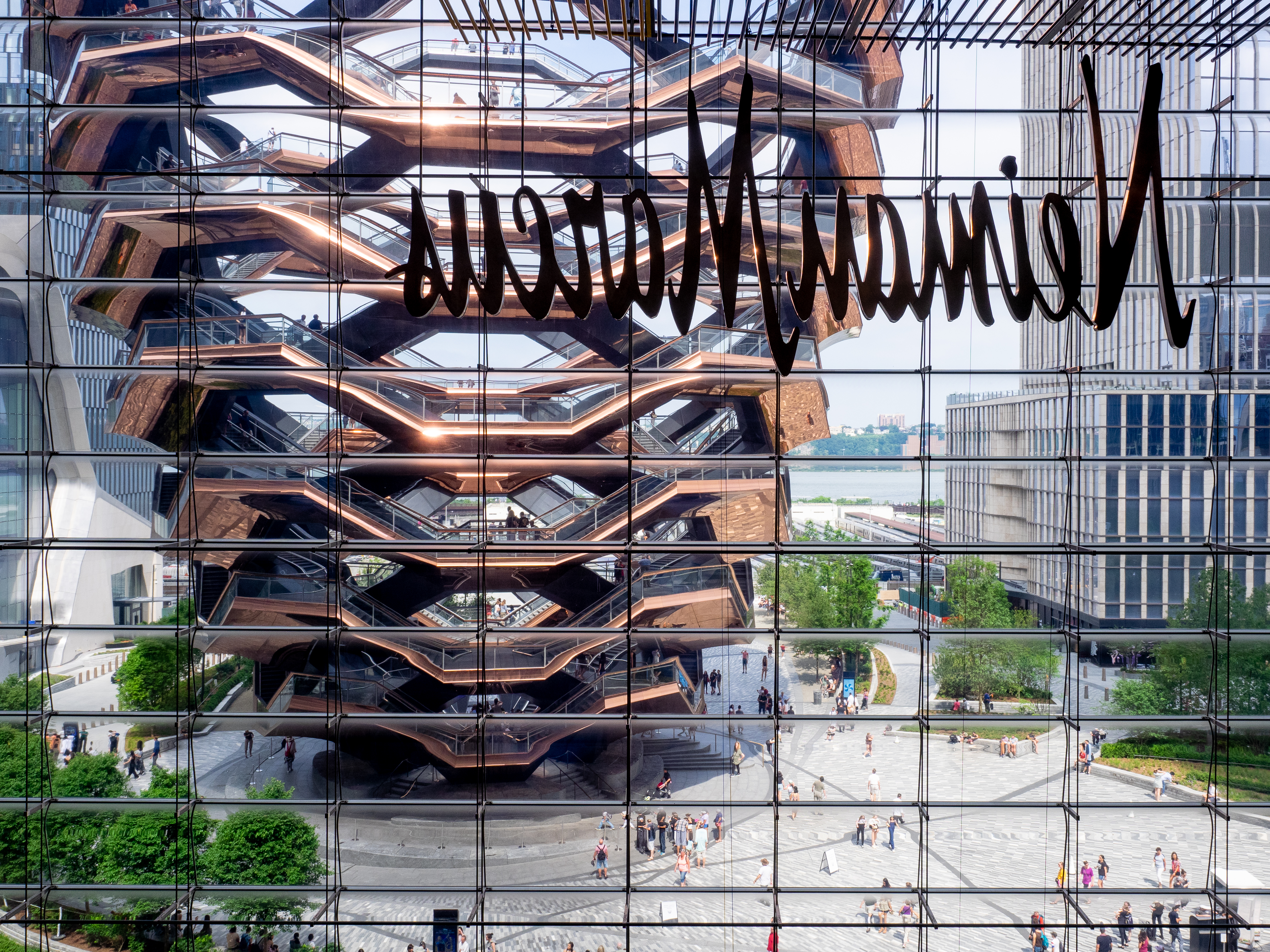 The Vessel seen from the Shops at Hudson Yards, its copper cladding catching the light against the plaza.