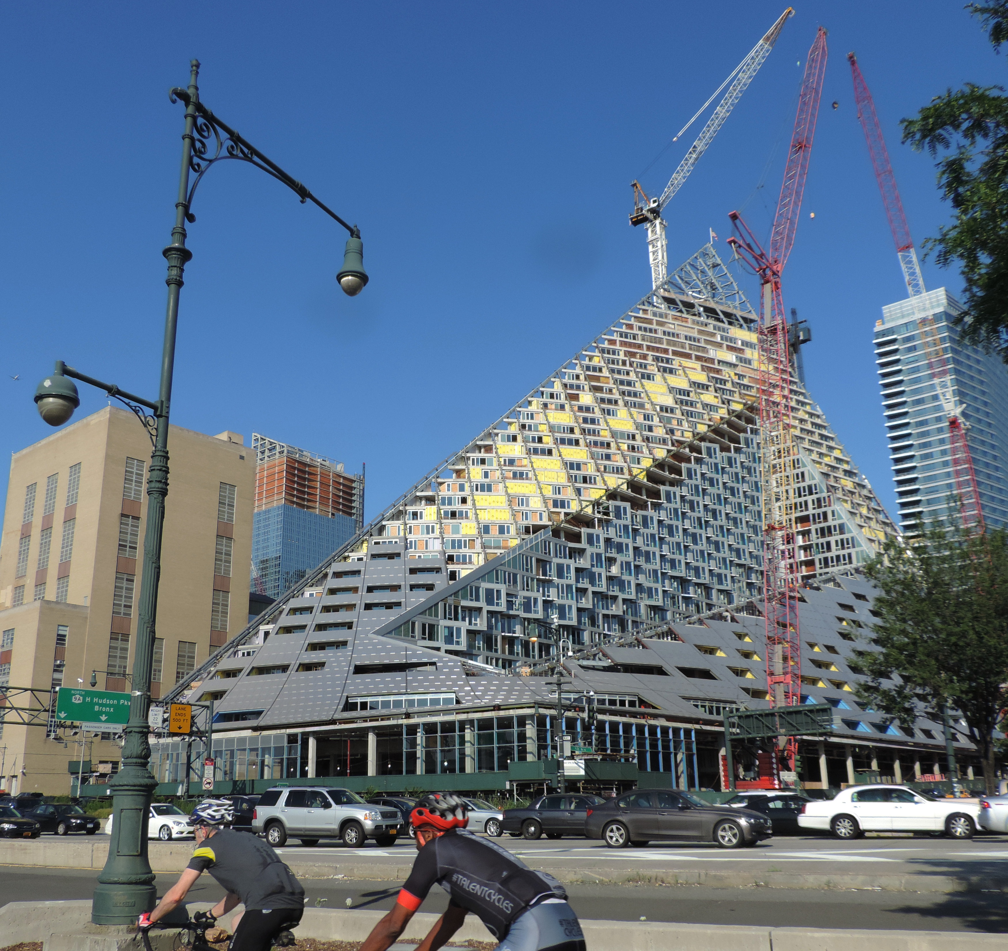VIA 57 West under completion in 2015, viewed from the street showing the low corners rising to the northeast peak.