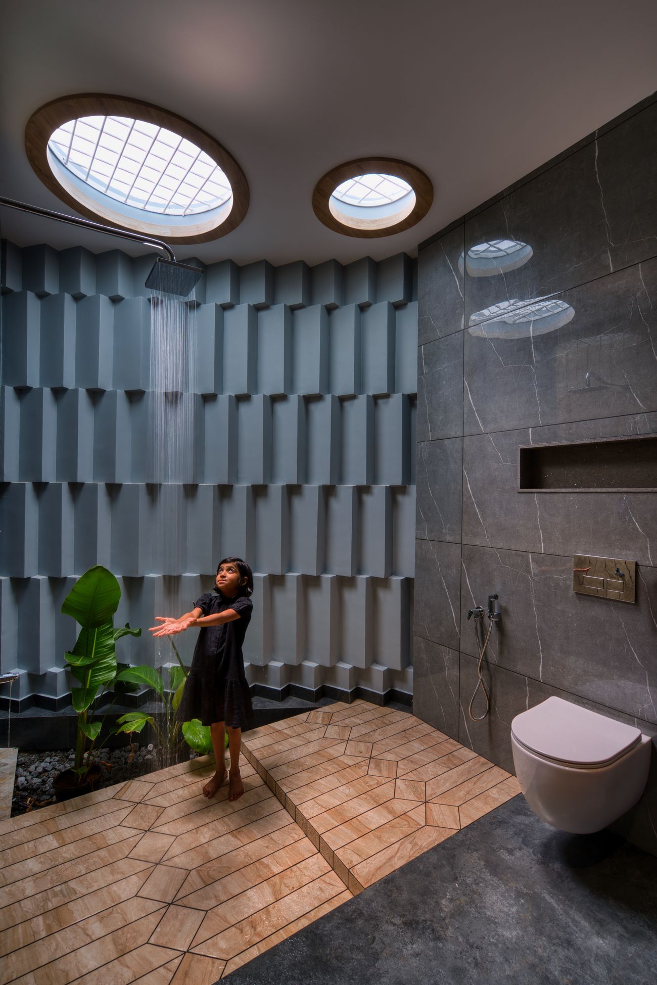 The curved perforated east wall with circular skylights casting patterned light