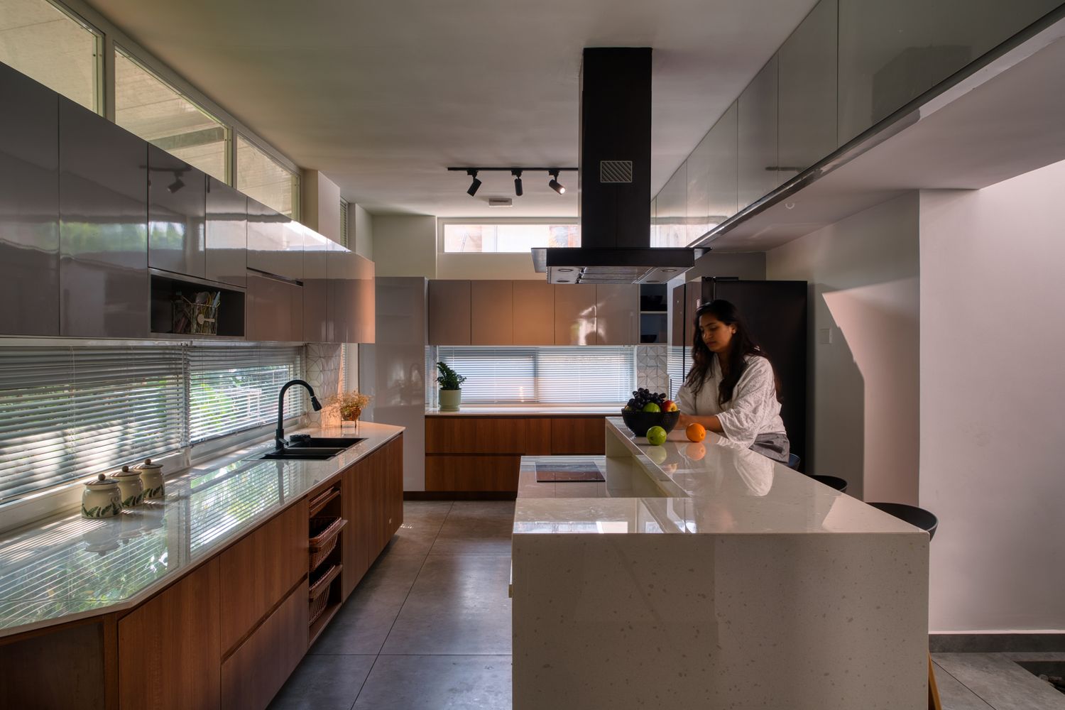 Open kitchen of Skew House with an island, extractor and indoor planting