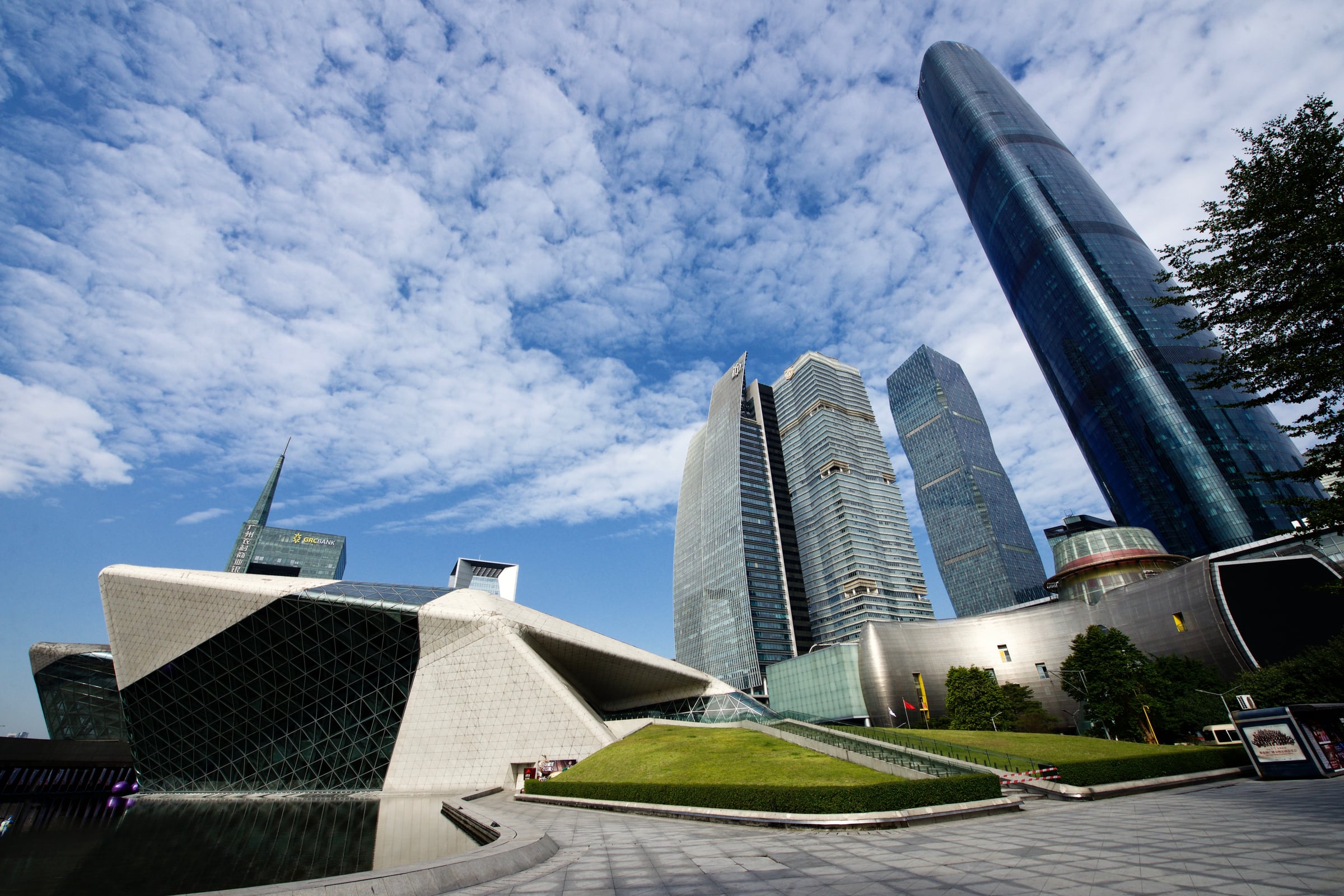 The Guangzhou Opera House (2010) by Zaha Hadid Architects — angular stone volumes beside the city's towers