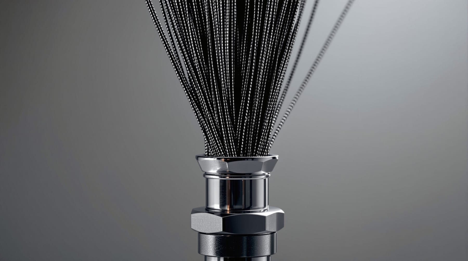 A bundle of fine carbon-fibre strands gathered and anchored into a polished metal fitting