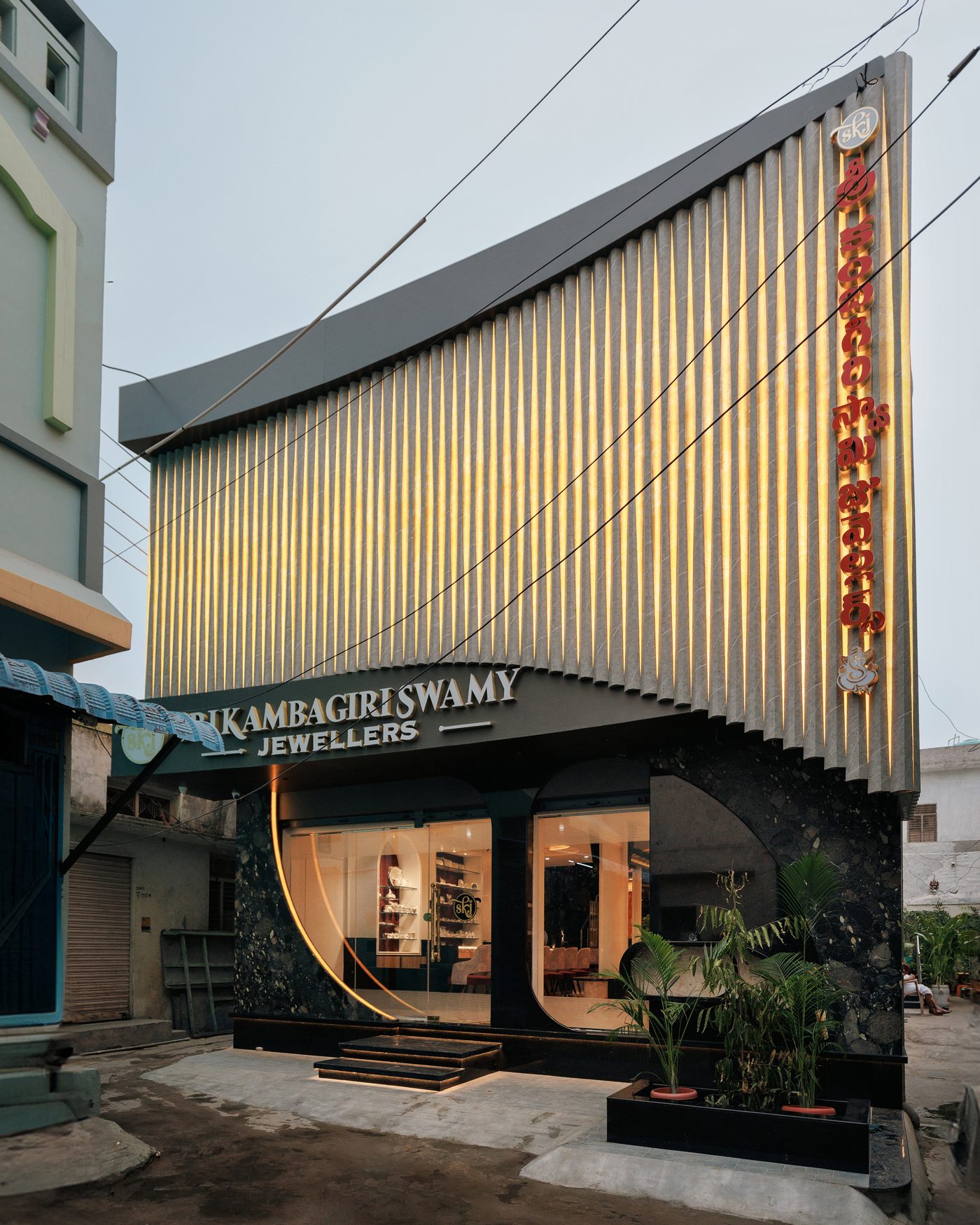 The Sri Kambagiri Swamy Jewellers facade at dusk, seen from the street