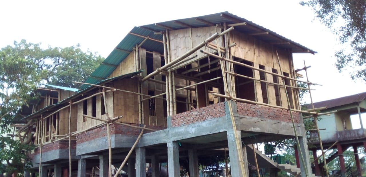 The bamboo superstructure of a barrack block rising over its raised concrete platform
