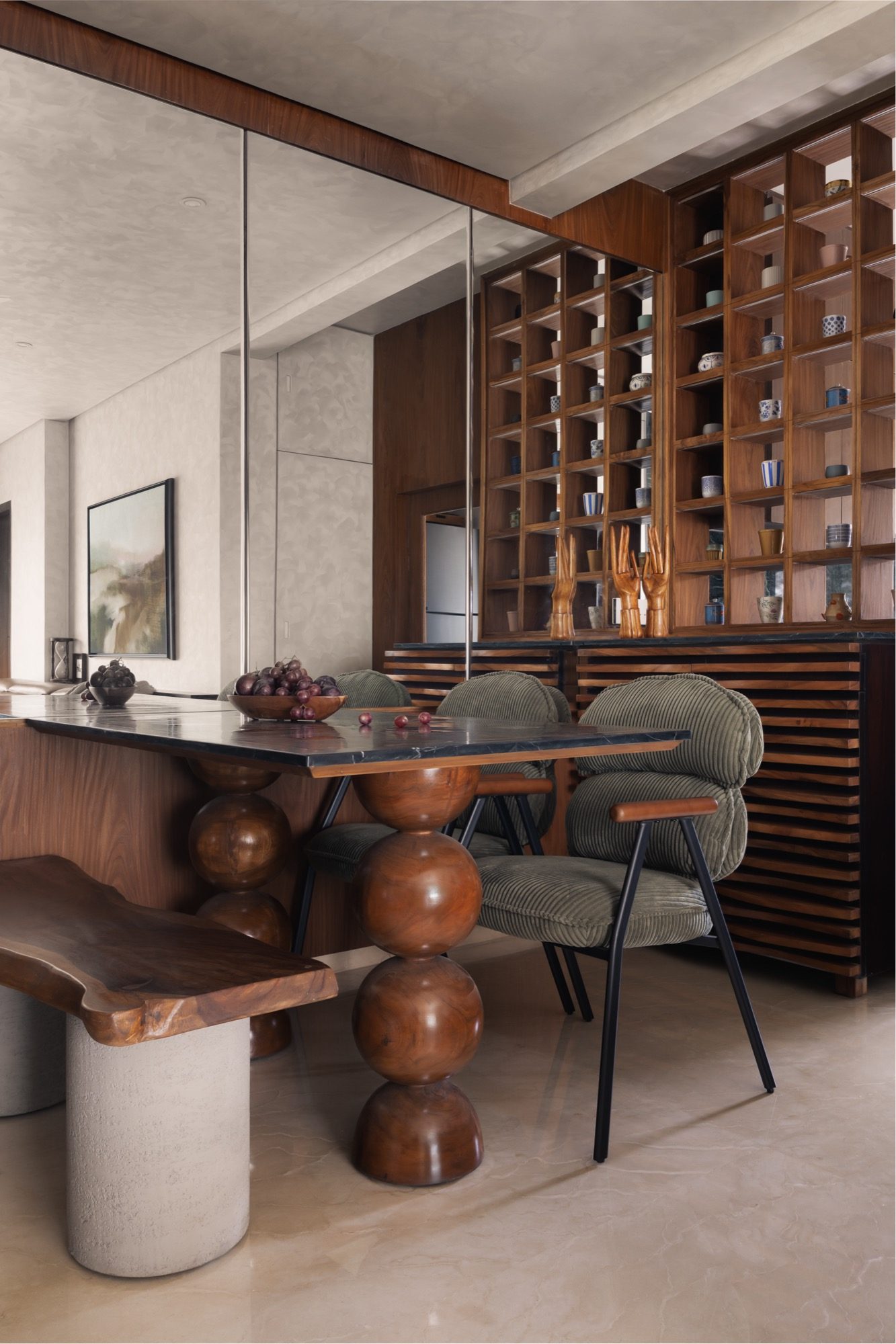 A corner of the Plum House apartment — warm materials, soft evening light on brass and stone