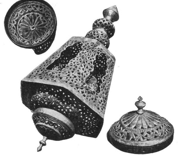 Black-and-white archival photograph of a pierced metal hanging lampshade shown with its separate top cap and bottom cap