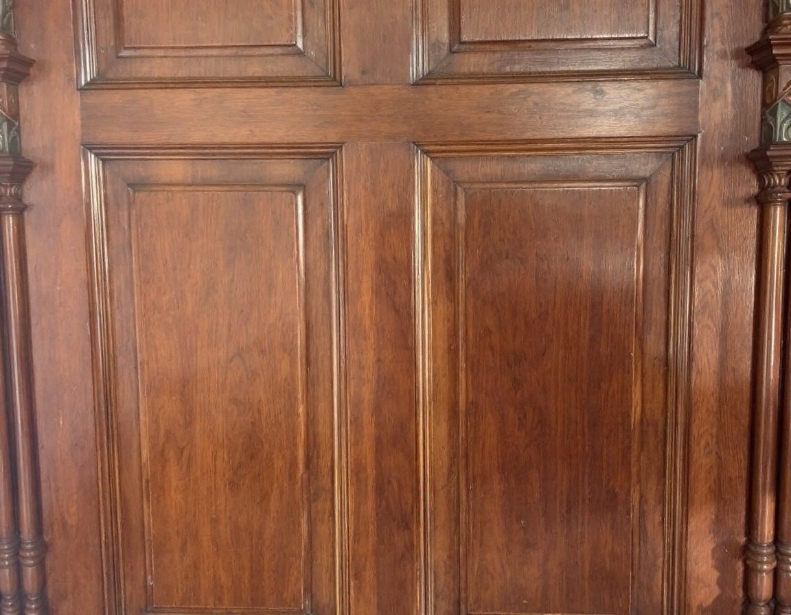 A traditional teak panelled door with stiles, rails and raised panels.