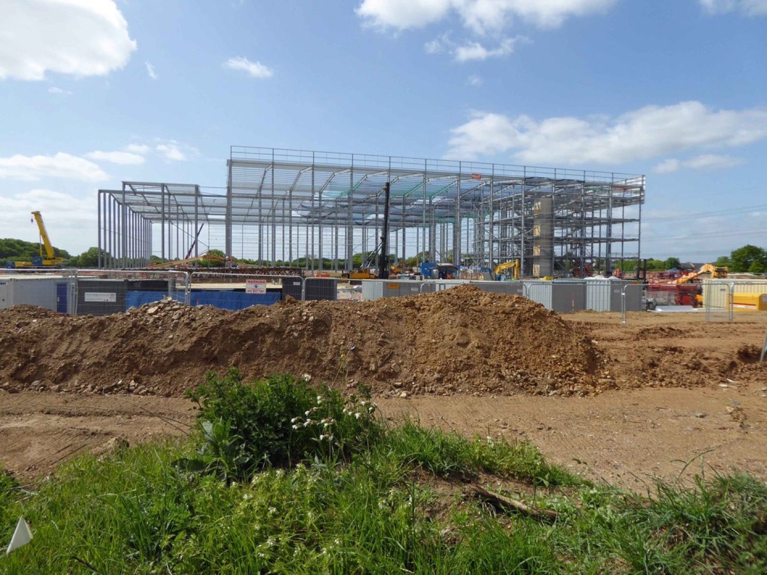 A pre-engineered steel building frame — factory-made portals bolted together on site.
