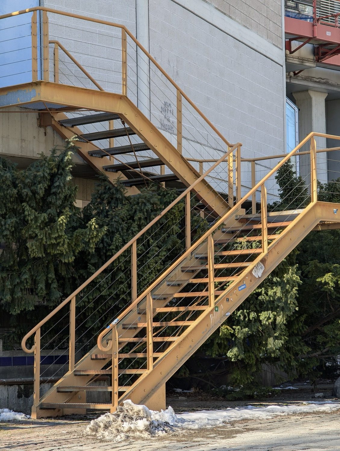 An external steel staircase — its stringers, open treads and balustrade.
