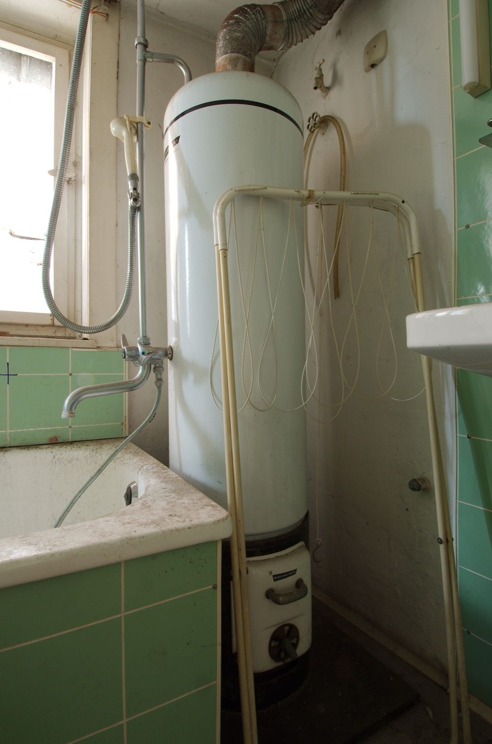 A hot-water boiler unit — heating water for domestic supply and heating loops.