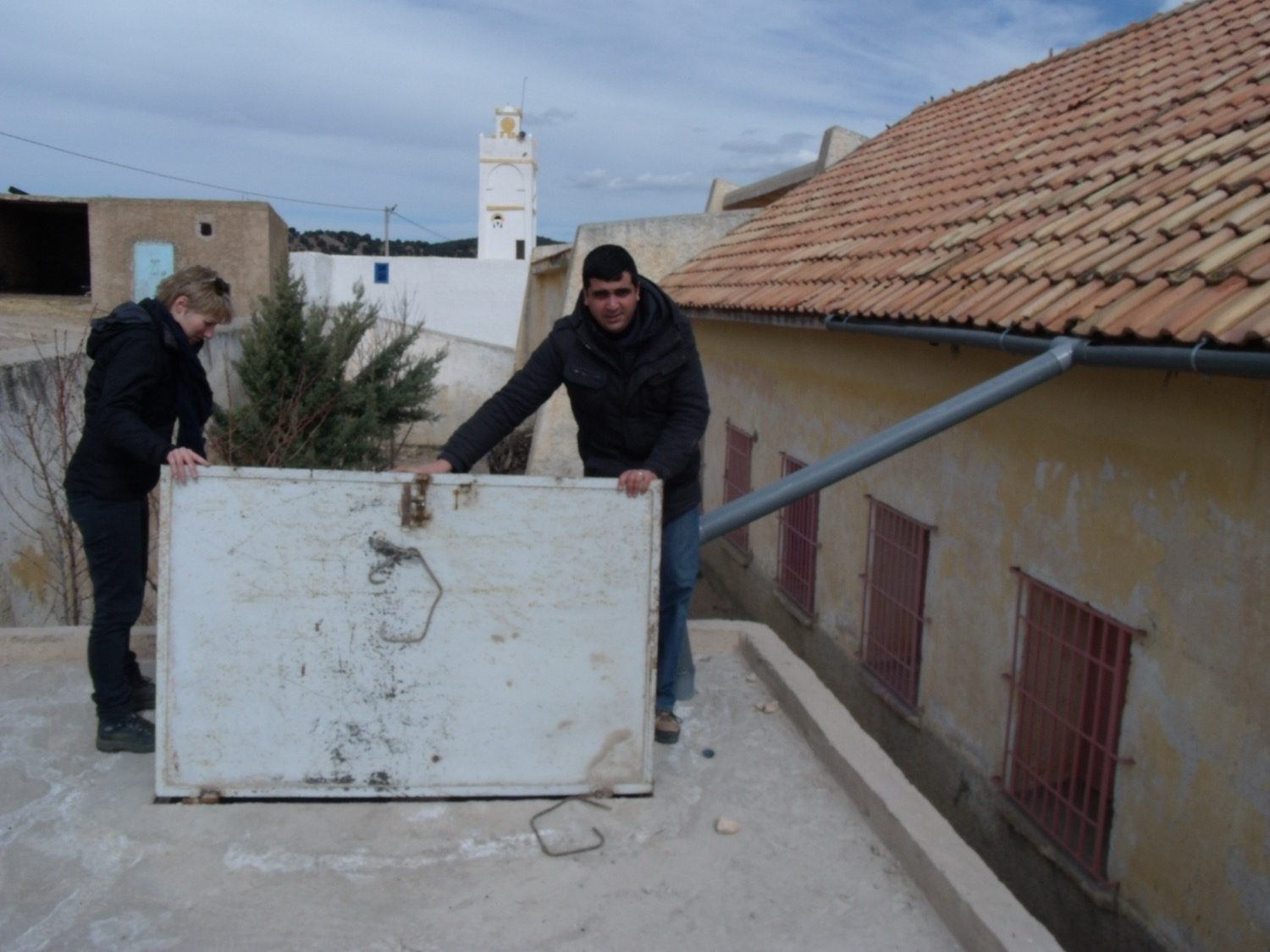 A rooftop rainwater-harvesting recharge pit — roof runoff directed to replenish the ground water.