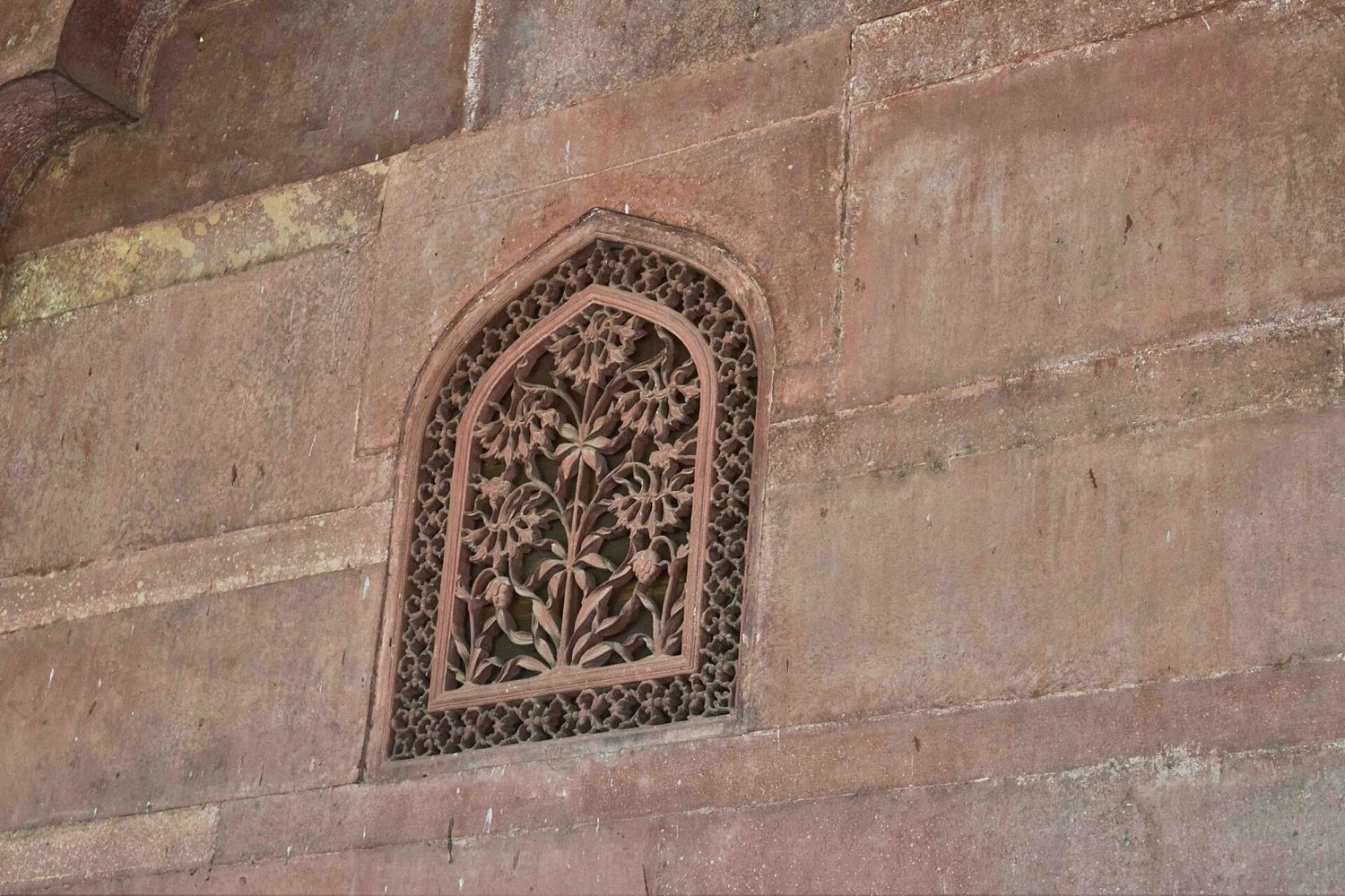 A jaali screen — shading, diffusing light and speeding airflow through its perforations.