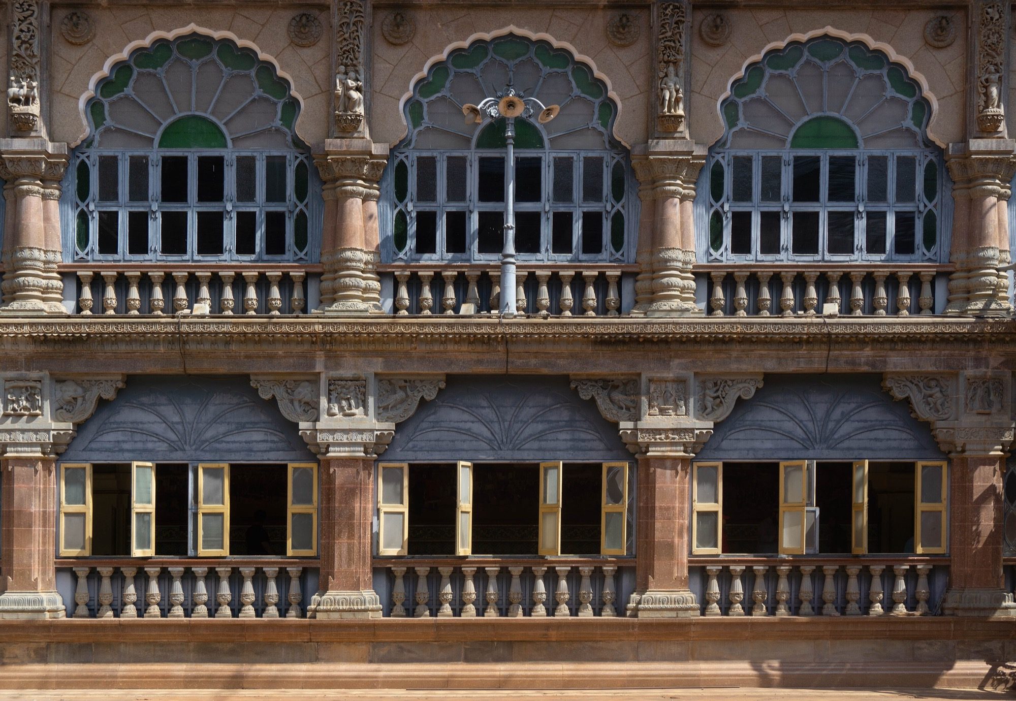 A detail of Mysore Palace (Amba Vilas), built 1897–1912 to Henry Irwin's design — the cusped Indo-Saracenic arcades, blending Indo-Islamic, Rajput, Hoysala and Gothic.