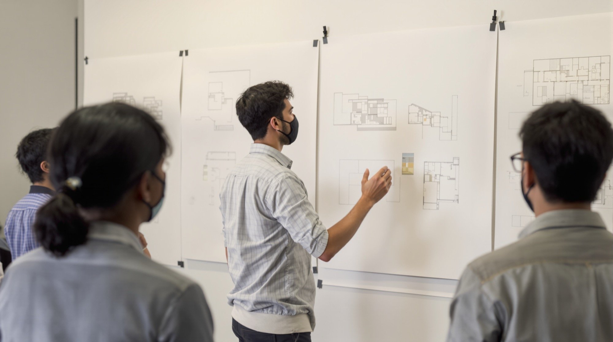 A studio jury — the drawing makes the case.