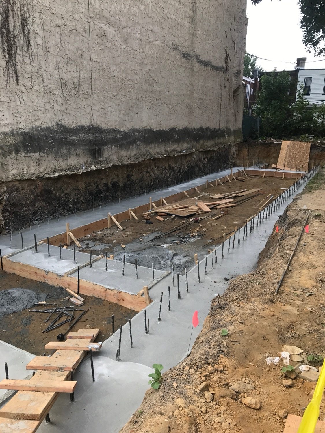 Concrete being placed and levelled over a slab's reinforcement during construction.