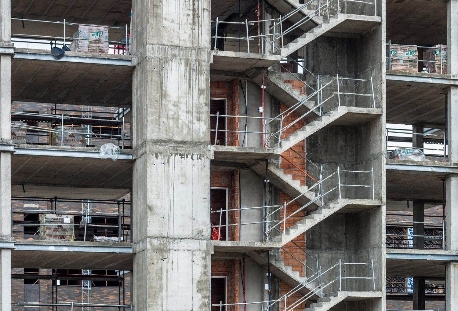 A cast reinforced-concrete staircase on site, the half-landing turning the flights through 180 degrees.