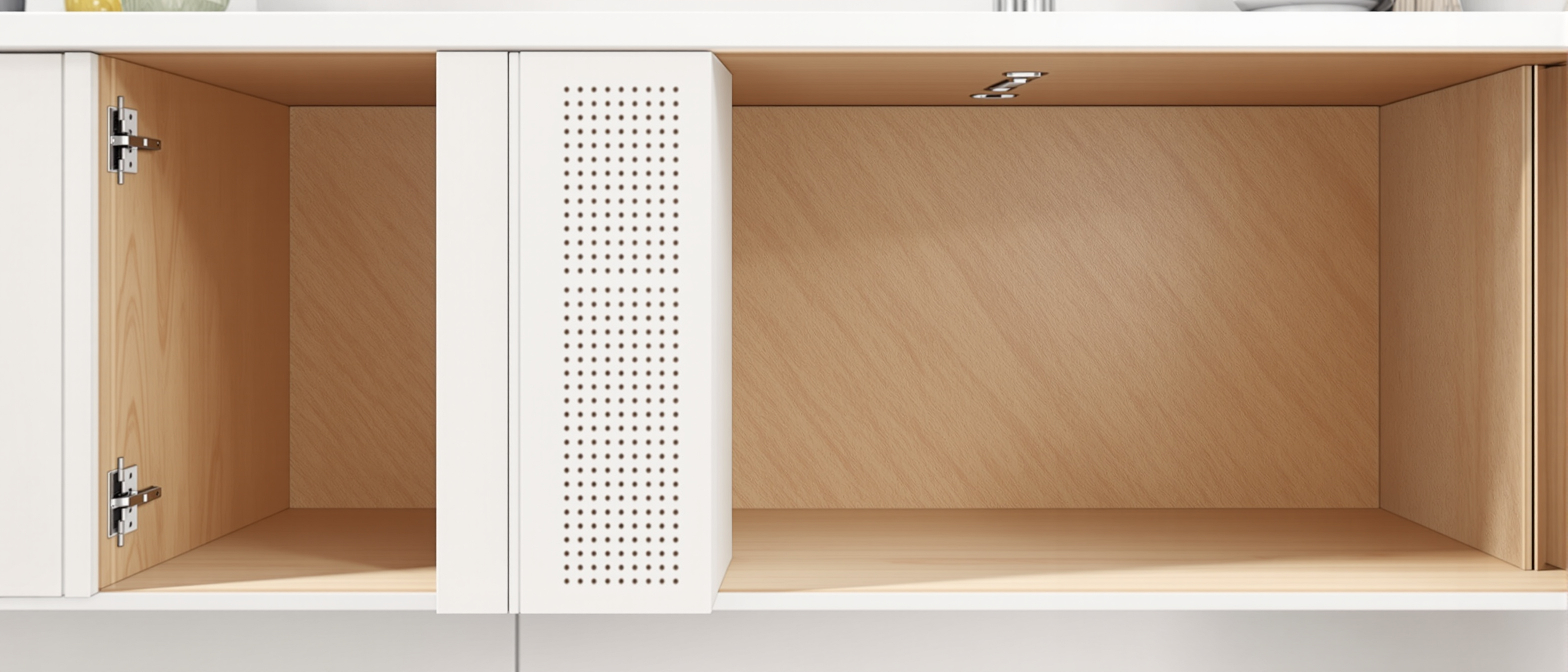 An open modular kitchen cabinet carcase showing the 32 mm hole columns, concealed hinges and soft-close drawer slides, in clean daylight