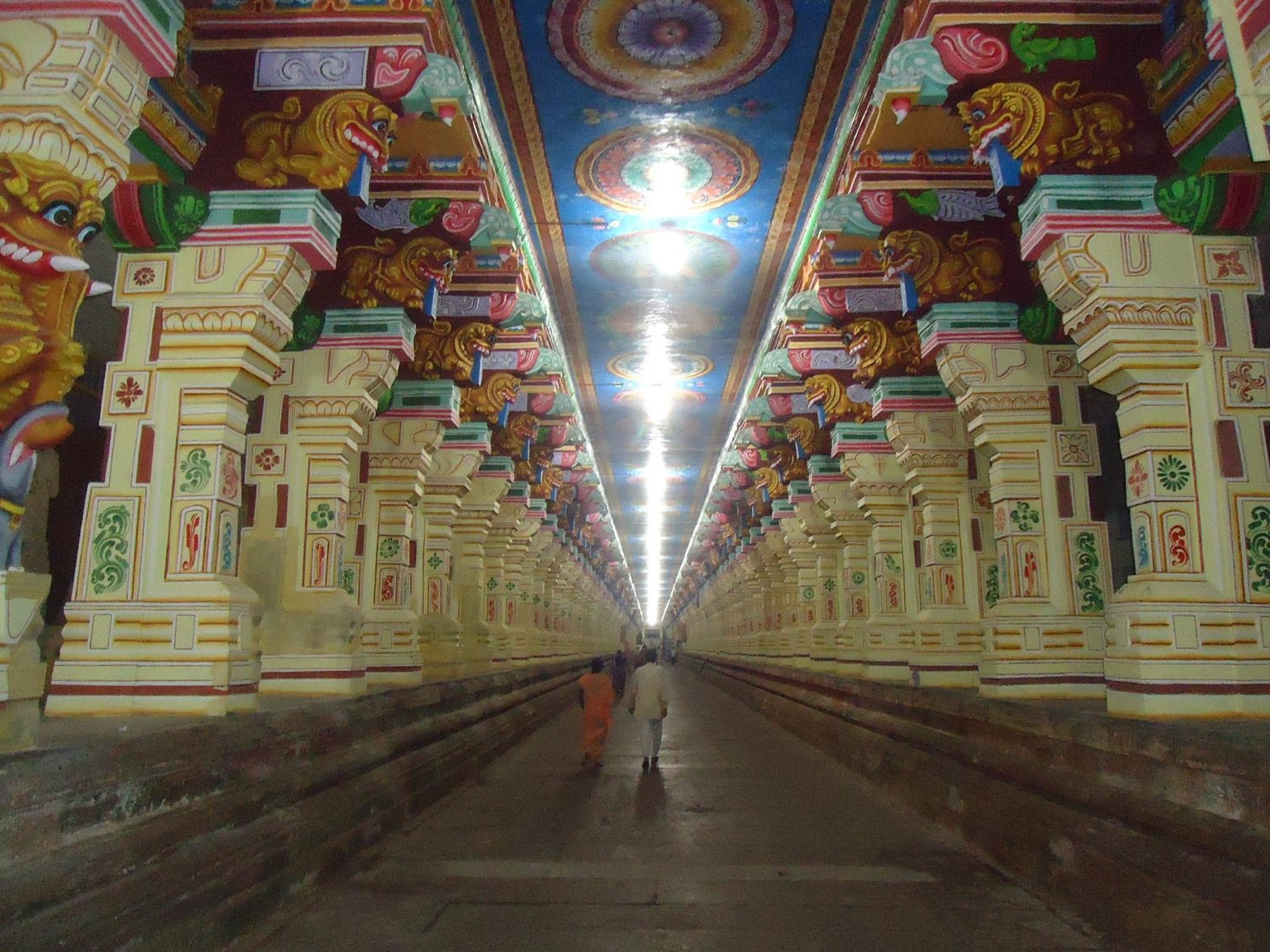 A long thousand-pillared mandapa, ranks of carved piers receding into shadow — a Nayak hall.