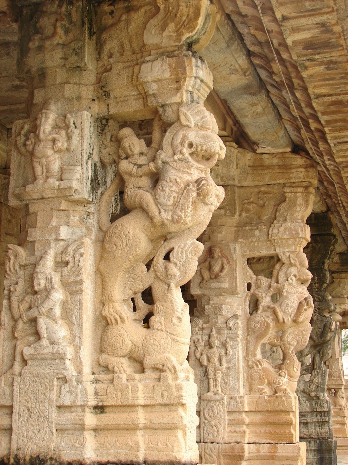 A Vijayanagara composite pier carrying a rearing yali, carved almost free of its shaft.