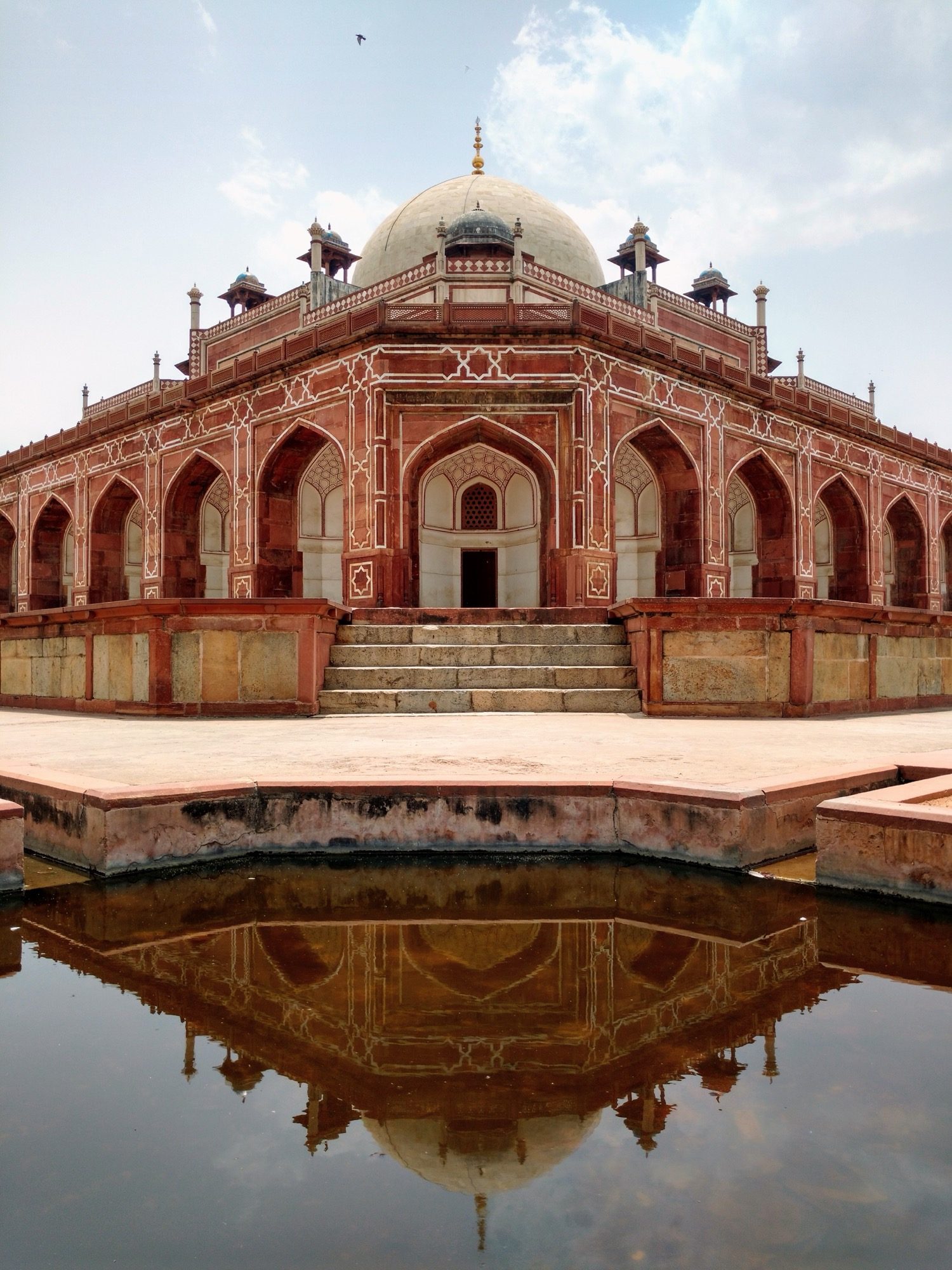 Humayun's Tomb, Delhi — the first great Mughal garden-tomb, its double dome over a charbagh, red sandstone inlaid with white marble.