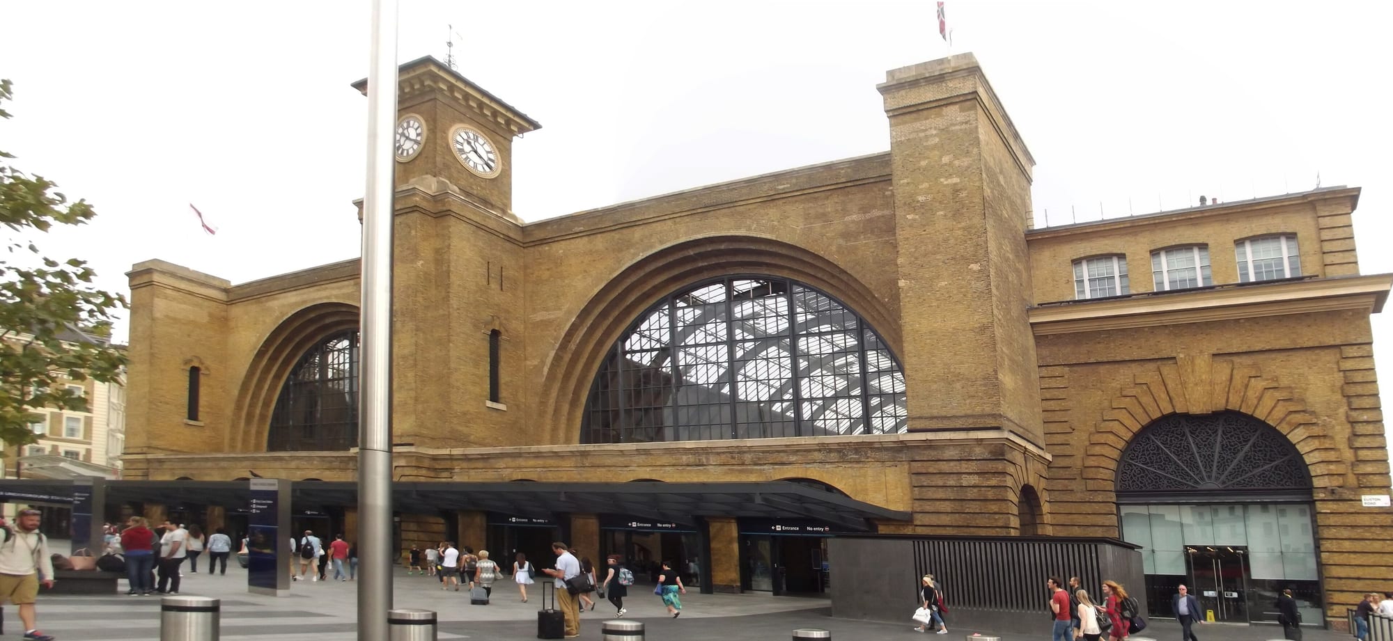 A great Victorian iron-and-glass train shed — a column-free span of wrought iron and glass, the engineer's cathedral of the railway age.
