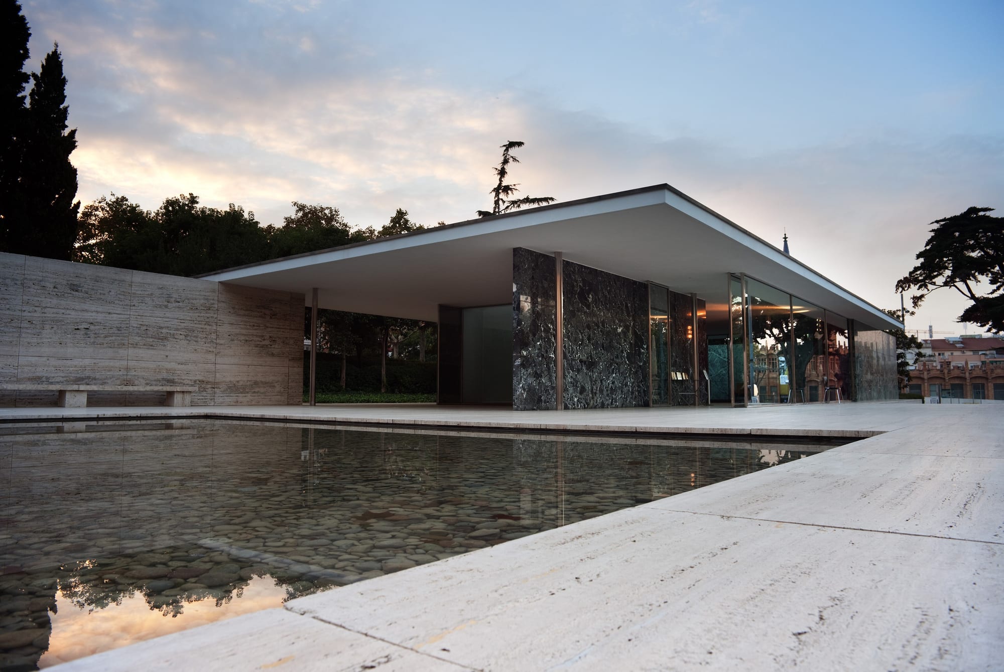 Mies van der Rohe's Barcelona Pavilion (1929) — a flat roof floating on chrome columns over planes of marble, glass and water; pure flowing space.