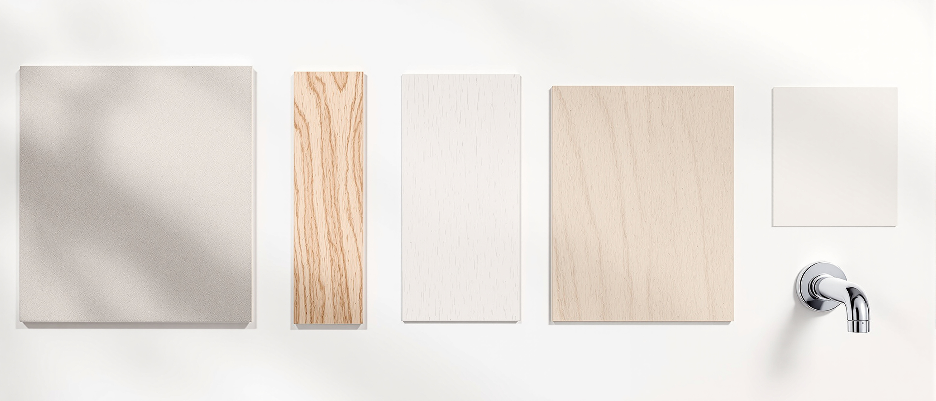 A flat-lay of interior finish samples — tile, laminate, timber, paint swatch and a tap fitting — arranged in a row on a light surface in warm daylight, no text