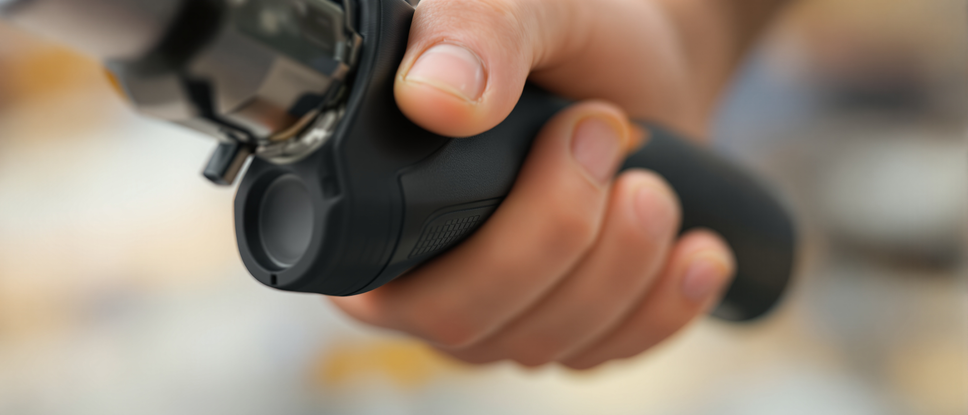 A close-up of a hand comfortably gripping a well-designed ergonomic tool handle with a soft contoured grip, warm daylight, tactile and precise, no text